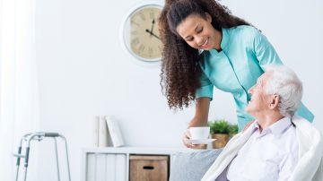 Nurse helping patient - long-term healthcare solutions